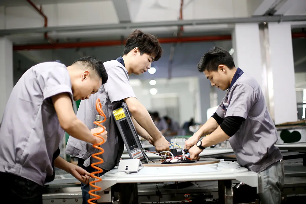 three workers are making machines